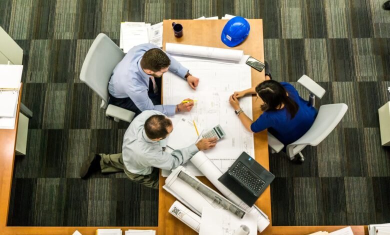 6 Tips to Lower Down Project Management Costs 1 three people sitting beside table